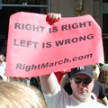 From the sidelines a Pro-Bush demonstrator waves his banner.