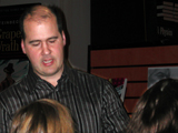 Krist signs copies of his book after the lecture.
